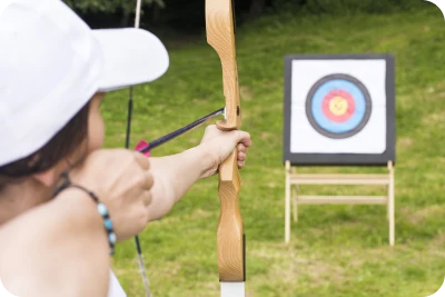 young-female-archer-holding-his-bow-aiming-target-sport-recreation-concept 1